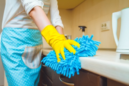Kitchen cleaning concept. Female hands in gloves closeupの写真素材