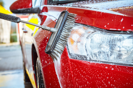 Contactless car wash self-service. Young man washing his carの写真素材