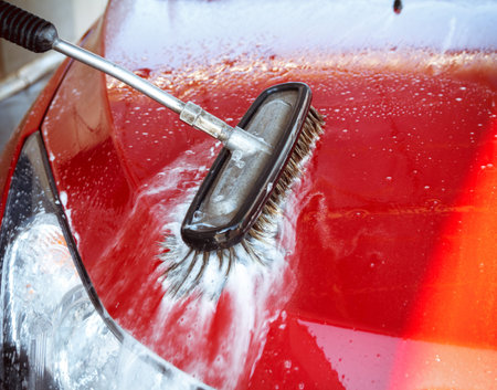 Contactless car wash self-service. Young man washing his car