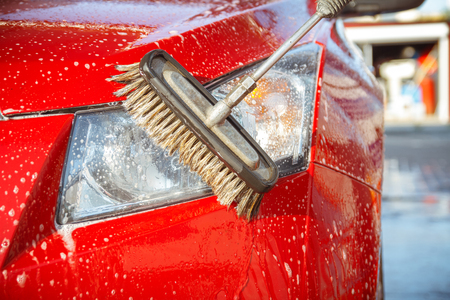 Contactless car wash self-service. Young man washing his carの写真素材