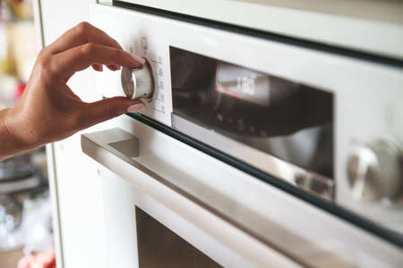 The choice of the eco mode of operation of the electric oven. Energy saving concept. Rational use of energy resourcesの写真素材