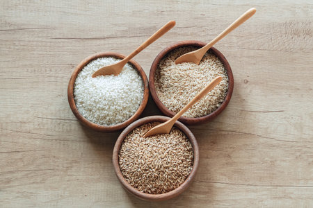 Set of different types of rice and cereals in the wooden bowlsの写真素材