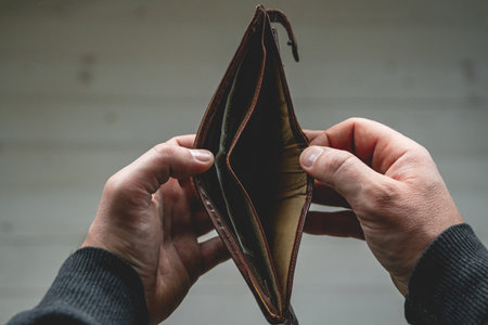 An Empty wallet in the hands of a young man