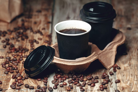 take away a coffee cup and coffee beans on wooden backgroundの写真素材