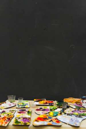 Set of many palettes on the artist's workplace in the studio