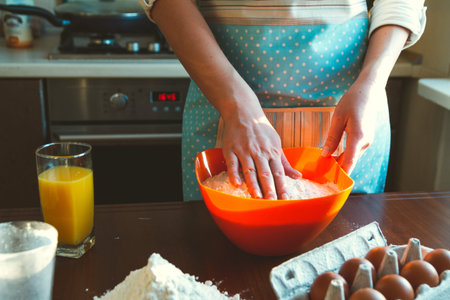 Young Woman cooking in the Kitchen, prepares the dough for baking