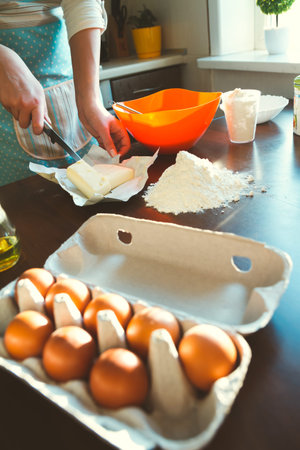 ingredients for baking close up. against the background of a young woman prepares dough