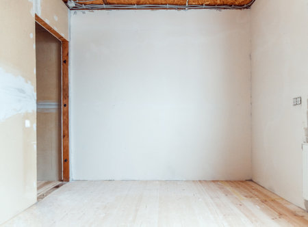 Empty room with wooden floor and newly painted white wall in background. Room renovation concept.の写真素材