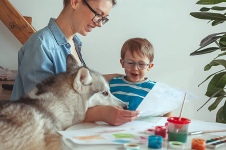 Kanistherapy, Mom and child paint together at home with a dog