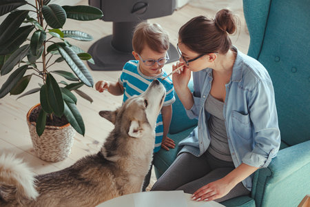 Kanistherapy, Mom and child paint together at home with dogの写真素材