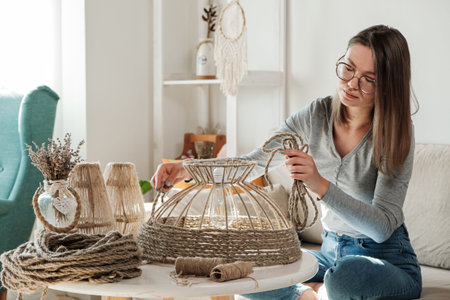 Woman makes handmade diy lamp from jute rope