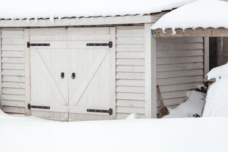 A Snow covered wooden shed after heavy snowfallの写真素材