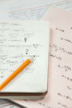 Math formulas are written in pencil on piece of paper, math problemsの写真素材