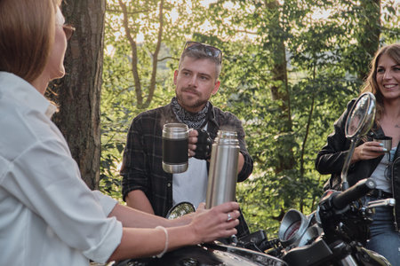 Meeting A company of friends of motorcyclists bikers on motorcycles stopped on the roadside having...