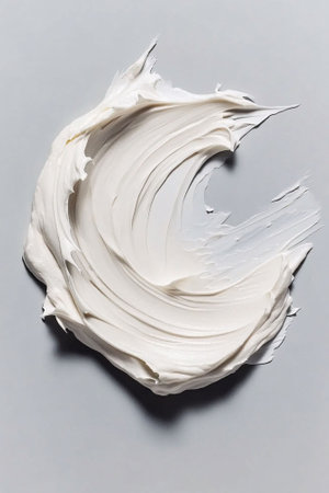 High-definition macro shot of thick, luxurious white moisturizing cream in a smooth, swirling texture on a light gray background, highlighting skincare product texture.の素材