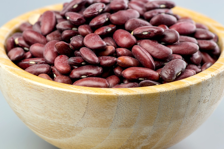 Closeup raw kidney beans in wooden bowlの写真素材