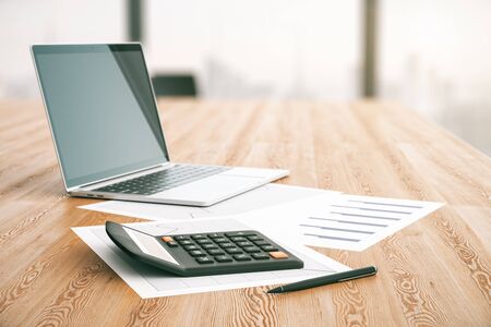Close up of wooden table with calculator and laptop. Accounting concept. 3D Renderingの写真素材