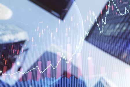 Double exposure of abstract financial graph with world map on office buildings background, forex and investment conceptの写真素材