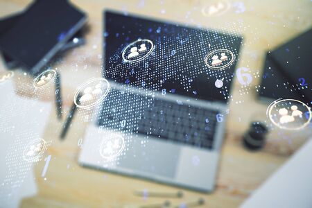 Double exposure of social network icons concept with world map and modern laptop on background. Marketing and promotion conceptの写真素材