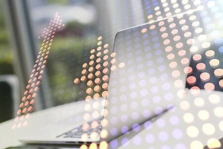 Double exposure of creative abstract upward arrows hologram on laptop background. Ambition and challenge conceptの写真素材