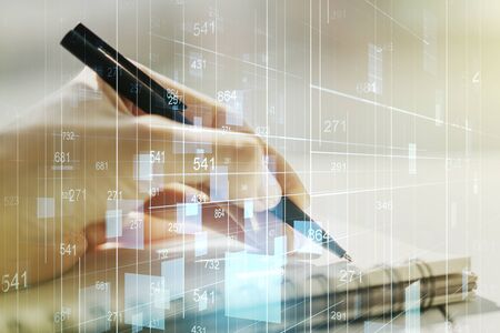 Abstract creative stats data concept with woman hand writing in notebook on background. Multiexposureの写真素材