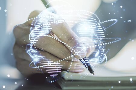 Abstract graphic digital world map with connections and woman hand writing in diary on background, globalization concept. Multiexposureの写真素材