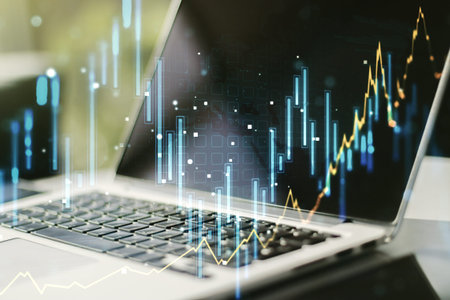 Multi exposure of abstract financial graph on laptop background, financial and trading concept