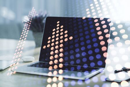 Double exposure of creative abstract upward arrows hologram on laptop background. Ambition and challenge conceptの写真素材