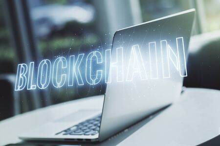 Double exposure of blockchain technology hologram on laptop background. Research and development decentralization software conceptの写真素材