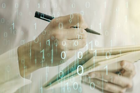 Creative abstract binary code hologram and man hand writing in diary on background, AI and machine learning concept. Multiexposureの写真素材