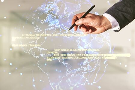 Multi exposure of developer's hand with pen working with abstract programming language hologram and world map on blurred office background, artificial intelligence and neural networks conceptの写真素材