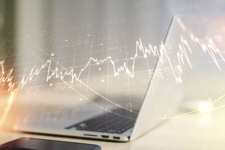 Multi exposure of abstract financial graph on laptop background, financial and trading conceptの写真素材