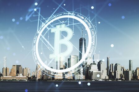 Double exposure of creative Bitcoin symbol hologram on New York city skyscrapers background. Cryptocurrency conceptの写真素材