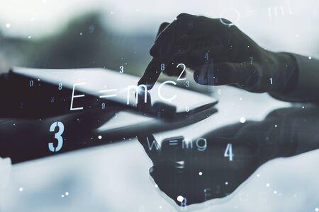 Creative scientific formula illustration with finger presses on a digital tablet on background, science and research concept. Multiexposureの写真素材