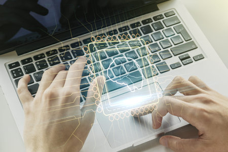 Double exposure of creative human brain microcircuit with hand typing on computer keyboard on...