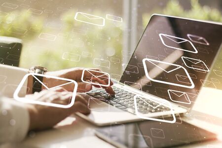 Creative abstract postal envelopes sketch with hands typing on computer keyboard on background, e-mail and marketing concept. Double exposureの写真素材