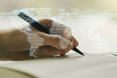 Multi exposure of abstract creative digital world map and man hand writing in notebook on background, tourism and traveling conceptの写真素材