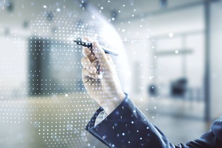 Man hand with pen working with abstract creative digital world map on blurred office background, globalization concept. Multiexposureの写真素材