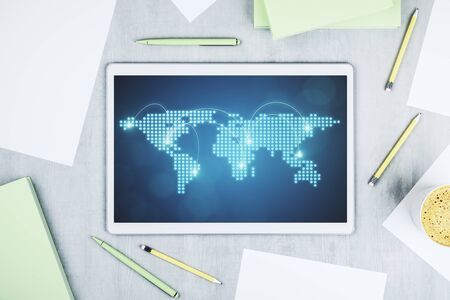 Abstract creative world map with connections on modern digital tablet screen, international trading concept. Top view. 3D Renderingの写真素材