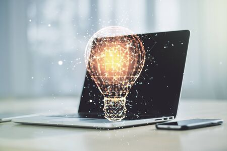 Creative light bulb hologram on modern laptop background, idea concept. Multiexposureの写真素材