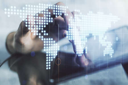 Double exposure of abstract digital world map and finger clicks on a digital tablet on background, research and strategy conceptの写真素材