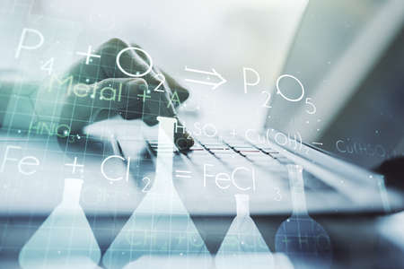 Creative chemistry concept with hands typing on laptop on background. Multiexposureの写真素材