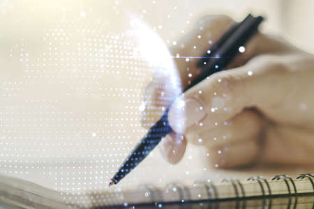 Double exposure of abstract digital world map and woman hand writing in notepad on background, big data and blockchain conceptの写真素材