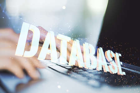 Double exposure of creative Database word hologram and hands typing on laptop on background, research and development conceptの写真素材