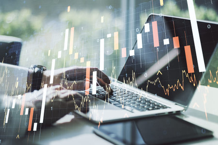 Multi exposure of abstract financial graph with world map and with hand typing on laptop on...