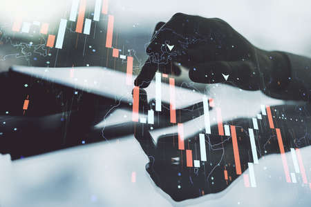 Creative abstract global crisis chart with world map sketch and hand working with a digital tablet on background, falling markets and collapse of global economy concept. Double exposureの写真素材