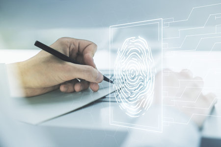 Double exposure of abstract creative fingerprint hologram with hand writing in notebook on...