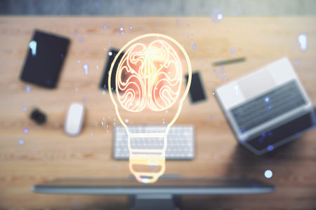 Double exposure of creative light bulb hologram with human brain on laptop background, idea and...