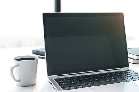 Modern laptop with blank screen on white table with cup of coffee. Mock up. 3D Renderingの写真素材