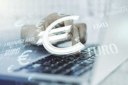 Creative EURO symbols sketch and hands typing on computer keyboard on background, strategy and...